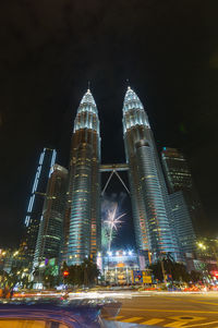 Illuminated modern buildings in city at night