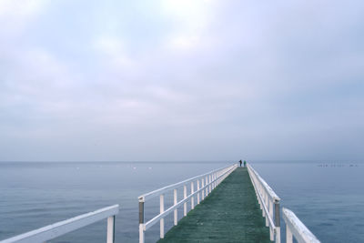 Pier amidst sea against sky