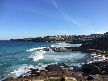 Scenic view of sea against clear blue sky