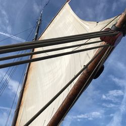 Low angle view of mast on sail boat against sky