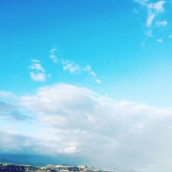 Low angle view of clouds over blue sky