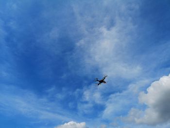 Low angle view of airplane flying in sky