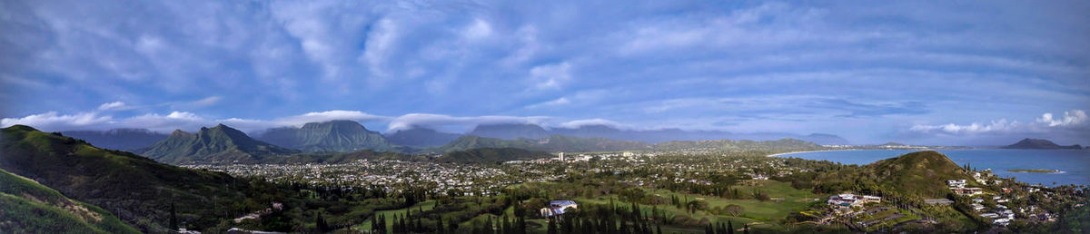 Panoramic view of sea and mountains against sky