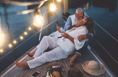 High angle view of couple kissing while sitting in boat