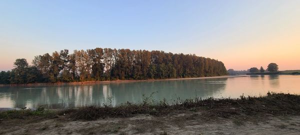 Scenic view of lake against sky during sunset