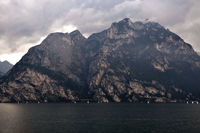 Scenic view of sea and mountains against sky