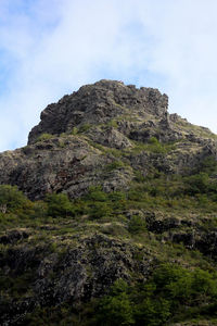 Low angle view of rock formation against sky