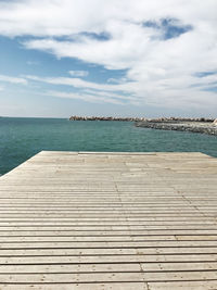 Pier over sea against sky