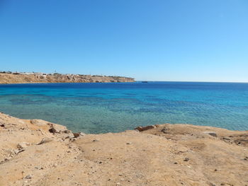 Scenic view of sea against clear blue sky