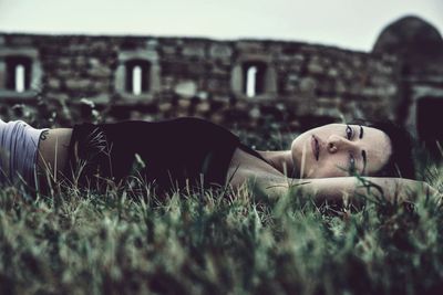 Dog resting on grassy field