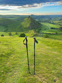 Hiking poles in front of dragons back hills in the peak district from the summit 