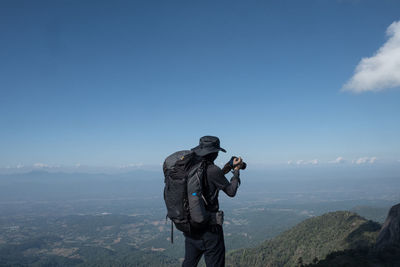 Rear view of man standing on mountain