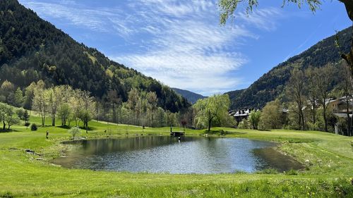 Scenic view of lake and mountains against sky