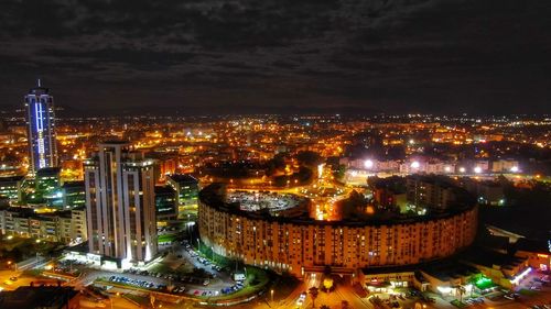High angle view of illuminated buildings in city at night