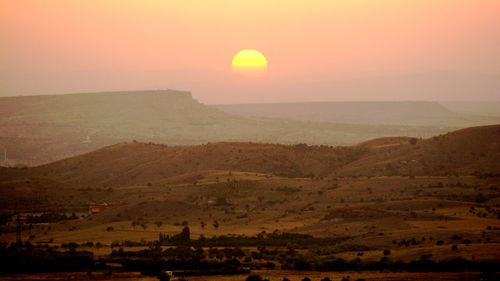 Scenic view of landscape at sunset