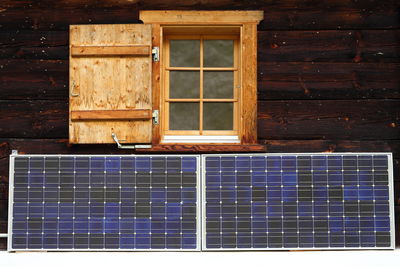 Solar panels on log cabin wall