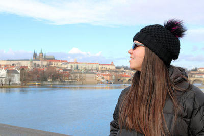 Portrait of woman looking at winter against sky