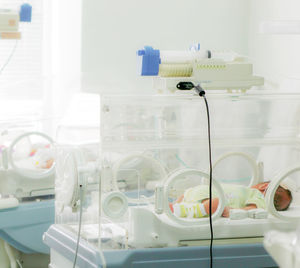 Newborn baby in hospital incubator