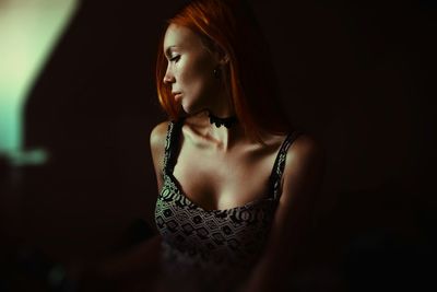 Beautiful young woman in darkroom