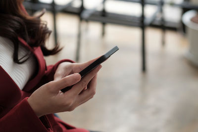 Midsection of woman using mobile phone