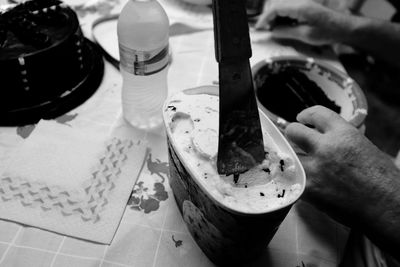 Cropped hands of man with dessert at table