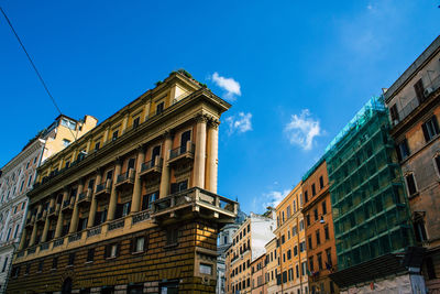 Low angle view of old building against blue sky