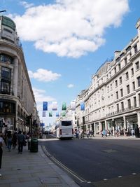 City street by buildings against sky