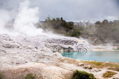 Scenic view of waterfall against sky