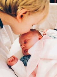 Close-up of baby sleeping on bed