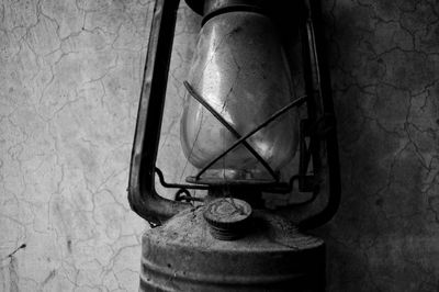 Close-up of old electric lamp against wall