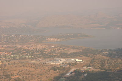 Aerial view of river and cityscape against sky