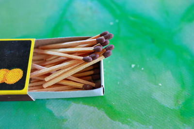 Matches in box, green background. macro photography. close-up shot. 