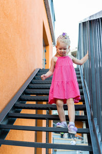 Portrait of boy standing on staircase