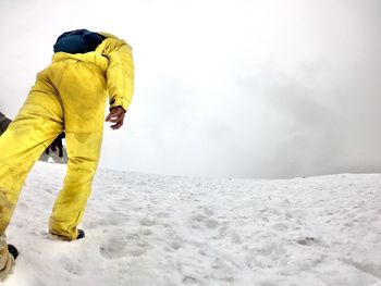 Midsection of man standing on snow covered landscape