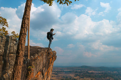 Man standing on mountain against sky