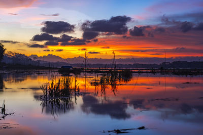 Scenic view of lake against orange sky