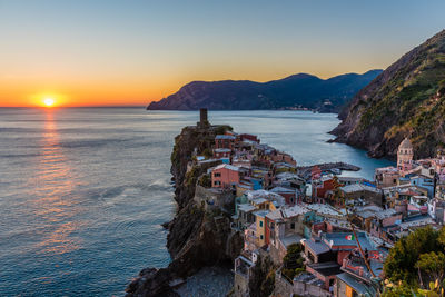 High angle view of buildings by sea at vernazza during sunset