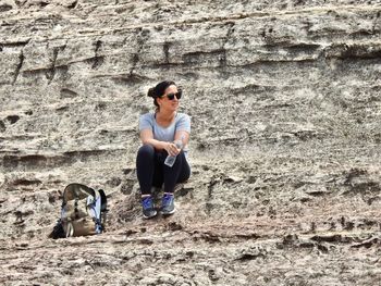 Full length of woman with dog standing outdoors