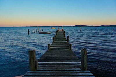 Pier over sea against clear sky