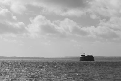 Boat sailing on sea against sky
