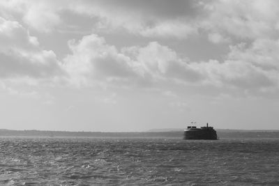 Boat sailing on sea against sky