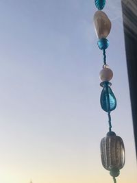 Low angle view of electric lamp against blue sky