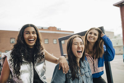 Happy multiracial young friends enjoying together