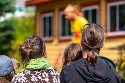 Rear view of people against blurred background