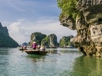 Scenic view of rocks in sea against sky