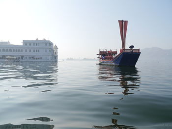 Boat on sea against clear sky