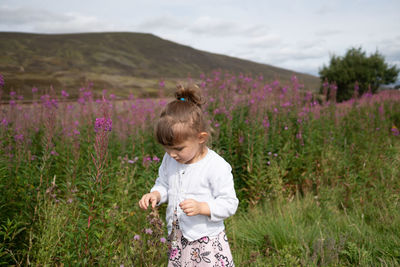 Cute girl looking at flowers