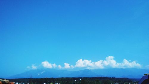 Scenic view of mountains against blue sky