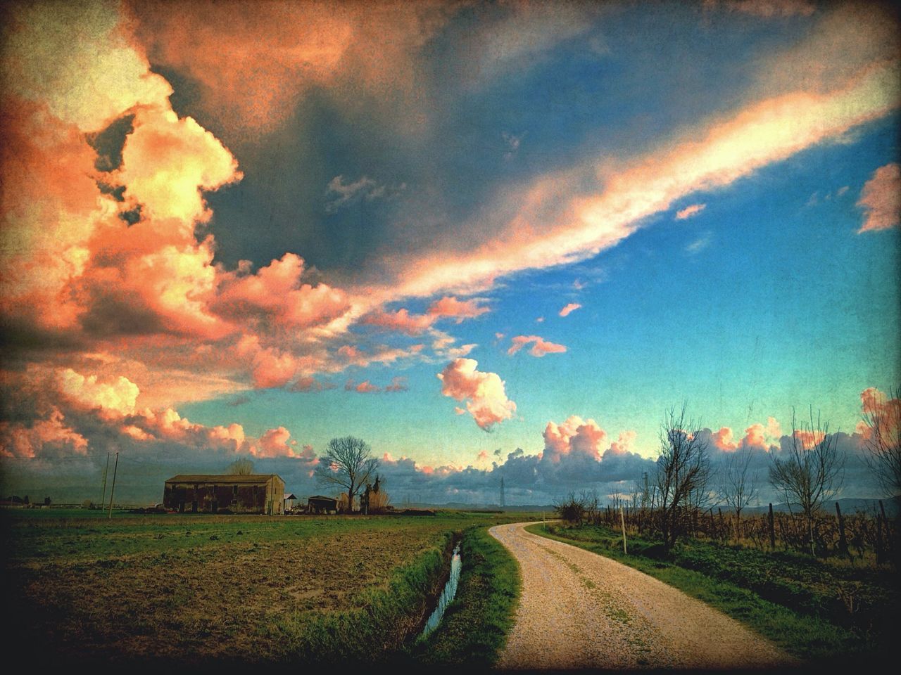 sky, the way forward, field, cloud - sky, rural scene, landscape, sunset, tranquility, tranquil scene, agriculture, scenics, nature, cloudy, beauty in nature, road, diminishing perspective, grass, cloud, vanishing point, farm