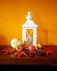 Close-up of fruits and lantern on table